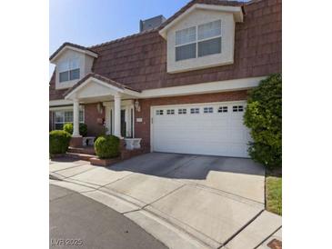 Charming two-story home boasts a well-manicured yard and an attached two-car garage at 3233 Southridge Ave, Las Vegas, NV 89121