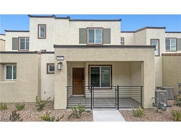 Charming townhome featuring a covered porch and modern architectural design, set against a clear blue sky at 3517 Arcadian King Ave, Las Vegas, NV 89106