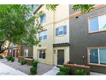 Inviting townhouse exterior featuring varied colors, desert landscaping, and a charming front door at 4650 Ranch House Rd # 86, North Las Vegas, NV 89031