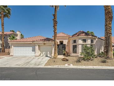 Charming single-story home featuring a three-car garage and desert landscaping at 5638 Wild Olive St, Las Vegas, NV 89118