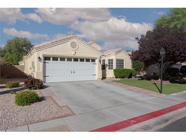 Charming single-story home featuring a two-car garage and well-maintained landscaping at 7697 Morning Lake Dr, Las Vegas, NV 89131