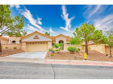 Charming single-story home features a well-maintained front yard with desert landscaping and a two-car garage at 10720 Sky Meadows Ave, Las Vegas, NV 89134