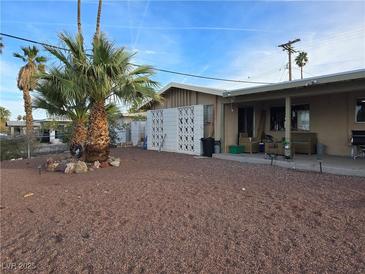 Desert landscaping and spacious covered patio create an inviting outdoor living space at 1389 Pawnee Dr, Las Vegas, NV 89169