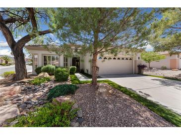 Charming single-story home featuring a two car garage and a beautifully landscaped front yard at 2029 Poppywood Ave, Henderson, NV 89012