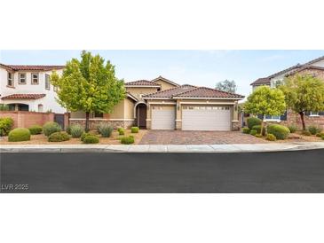 Charming single-story home featuring a two-car garage, well-maintained landscaping, and a red tile roof at 2116 Canvas Edge Dr, Henderson, NV 89044