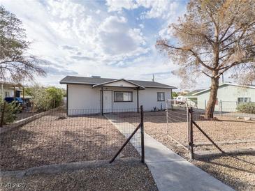 Charming single-story home featuring a fenced yard and sidewalk leading to the front door at 26 E Atlantic Ave, Henderson, NV 89015