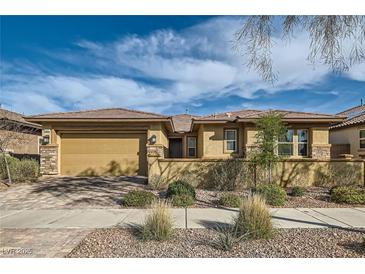Charming single-story home with a well-manicured lawn, desert landscaping, and an attached two-car garage at 262 Inflection St, Henderson, NV 89011