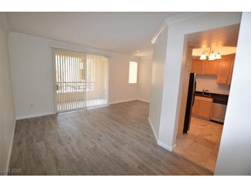 Bright living room featuring wood floors and access to outdoor balcony at 270 E Flamingo Rd # 136, Las Vegas, NV 89169