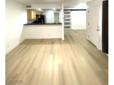 Spacious living room boasts modern flooring and leads to an open kitchen area at 4248 Tara Ave # 2, Las Vegas, NV 89102