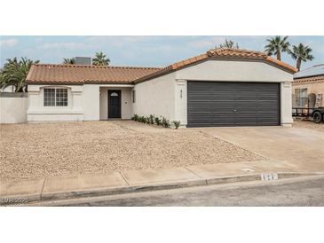 Charming single-story home with a low-maintenance front yard and attached two-car garage at 427 Wright Way, Henderson, NV 89015