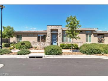 Charming single-story home with a stone accent entrance, lush landscaping, and a serene curb appeal at 4277 Sunrise Flats St, Las Vegas, NV 89135