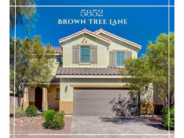 Charming two-story home featuring desert landscaping, a tile roof, and neutral-toned exterior paint at 5852 Brown Tree Ln, North Las Vegas, NV 89081