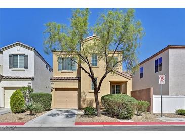 Two-story home with desert landscaping, a garage, and a tree in the front yard at 10162 Sunshine Village Pl, Las Vegas, NV 89183