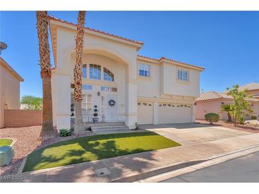 Inviting home featuring a well-manicured lawn and a welcoming front entrance with decorative wreath at 1035 Tabor Hill Ave, Henderson, NV 89074