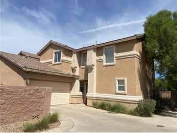 Charming two-story home with a two-car garage, tan stucco and tile roof at 1434 Summer Glow Ave, Henderson, NV 89012