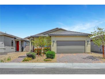 Charming single-story home featuring a paver driveway, desert landscaping, and a two-car garage at 2238 Thelen Ave, North Las Vegas, NV 89086