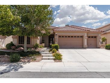 Charming single-story home with a three-car garage, tile roof and landscaped front yard with mature tree at 3522 Shonna Way, North Las Vegas, NV 89032