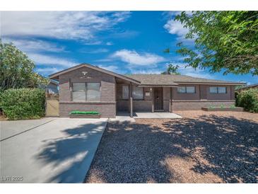 Charming single story home featuring brick veneer and desert landscaping at 416 Rossmoyne Ave, North Las Vegas, NV 89030