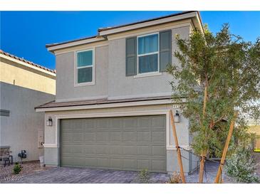 Charming two-story home featuring a two-car garage, landscaped yard, and a modern, neutral color palette at 4977 Birchland Manor Ave, Las Vegas, NV 89139