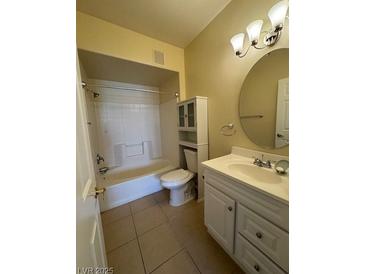 Cozy bathroom featuring a toilet, vanity, and shower over tub combo at 7159 S Durango Dr # 206, Las Vegas, NV 89113