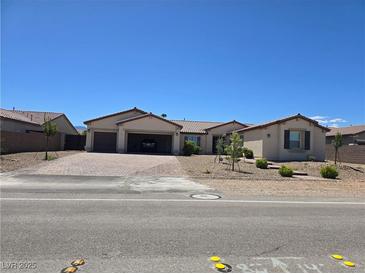 Inviting single-story home with a spacious three-car garage and desert landscaping for easy maintenance at 8665 Jerlyn St, Las Vegas, NV 89113