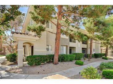 Attractive condominium building with well-maintained landscaping and mature trees at 9050 W Warm Springs Rd # 2051, Las Vegas, NV 89148