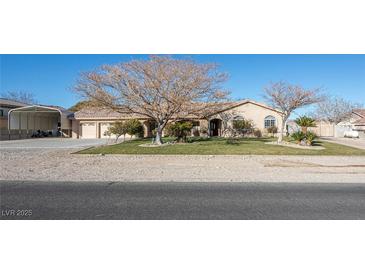 Attractive desert home with a well-manicured lawn and ample parking space at 10140 W Tropical Pkwy, Las Vegas, NV 89149