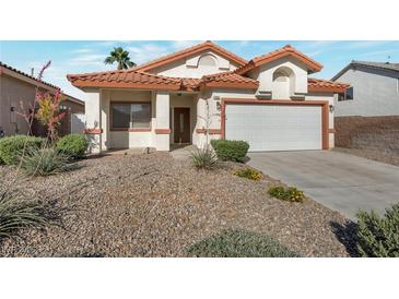 Charming single-story home featuring a desert landscape and a two-car garage at 2455 Silver Blossom Ln, Henderson, NV 89052