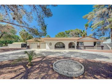Charming single-story home with a three-car garage and decorative metalwork at 4030 Del Monte Ave, Las Vegas, NV 89102