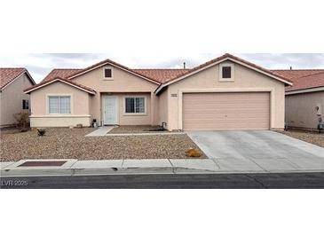 Charming single-story home featuring a two-car garage, low maintenance desert landscaping, and a cozy front porch at 4618 Zia Ridge St, North Las Vegas, NV 89031