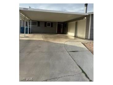 Front exterior of home with a covered carport and wide driveway for easy parking at 5804 Balzar Ave, Las Vegas, NV 89108