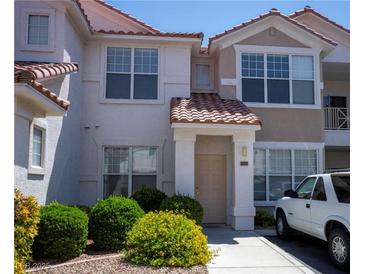 Charming two-story townhome with well-maintained landscaping and a welcoming front entrance at 8555 W Russell Rd # 2020, Las Vegas, NV 89113
