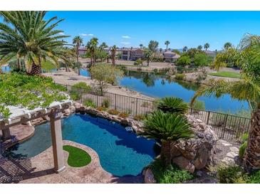 Inviting backyard pool overlooking the serene lake and lush greenery, a perfect outdoor oasis at 11359 Winter Cottage Pl, Las Vegas, NV 89135