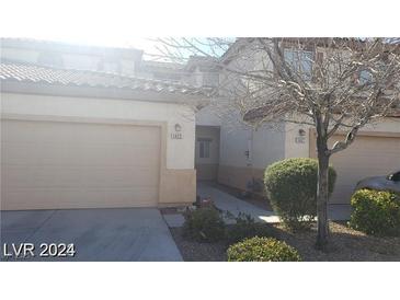 Charming home featuring a desert-landscaped front yard and two-car garage at 1423 Orange Jubilee Rd, Henderson, NV 89014