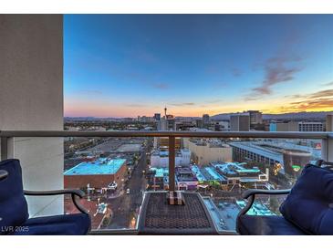 Enjoy breathtaking city views from this condo's balcony, featuring comfortable seating and a modern design at 150 Las Vegas Blvd # 1912, Las Vegas, NV 89101