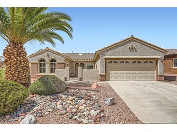 Charming single-story home with desert landscaping, large palm tree, and inviting curb appeal at 2810 Somerset Springs Dr, Henderson, NV 89052