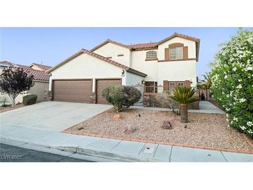 Charming two-story home with desert landscaping, a three-car garage, and a welcoming entrance at 4114 Jessica Marie St, North Las Vegas, NV 89032