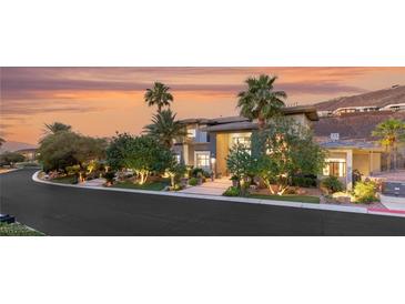 Stunning exterior featuring professional landscaping, mature trees, and a circular driveway at 584 Saint Croix St, Henderson, NV 89012