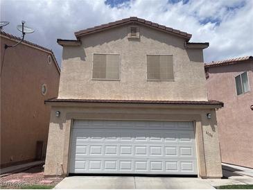 Charming two-story home featuring a spacious two-car garage and neutral color palette at 6086 Sunken River Trl, Las Vegas, NV 89118