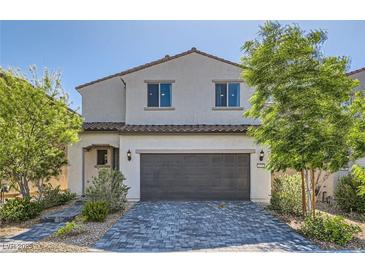Charming two-story home featuring a paved driveway and inviting curb appeal with mature trees and lovely landscaping at 6938 Feather Hill St, North Las Vegas, NV 89086