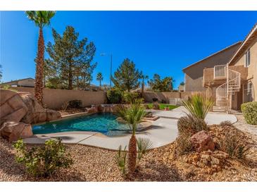 Beautiful backyard pool and spa surrounded by desert landscaping at 8809 Barium Rock Ave, Las Vegas, NV 89143