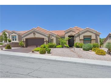 Charming single-story home featuring desert landscaping, a terracotta roof, and a two-car garage at 10632 Clarion Ln, Las Vegas, NV 89134