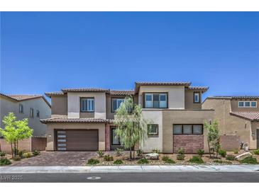 Two-story home featuring modern design elements, a two-car garage and manicured landscaping at 201 Carmel Sky St, Las Vegas, NV 89138