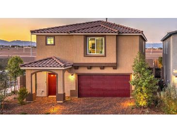 Two-story home boasts a red door, two-car garage, and manicured landscaping at 4433 Bayley Skye Ave # 104, Las Vegas, NV 89141