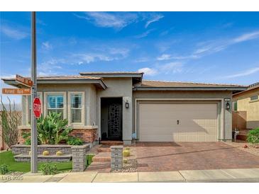 Charming single-story home featuring low maintenance desert landscaping, brick driveway, and a two car garage at 468 Harvest Rain, Las Vegas, NV 89011