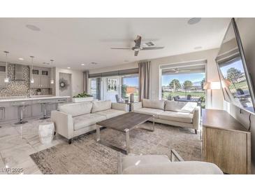 Spacious living room with modern furniture, recessed lighting, and sliding glass doors to the backyard at 4924 E Cactus Canyon Dr, Pahrump, NV 89061