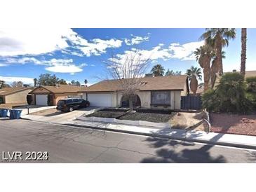 Charming single-story home with desert landscaping, two-car garage and mature palm trees at 5175 Palmyra Ave, Las Vegas, NV 89146