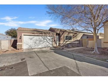 Charming single-story home featuring a two-car garage and desert landscaping at 5184 Mineral Lake Dr, Las Vegas, NV 89122