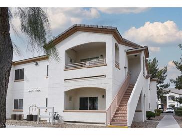 Inviting multi-level home with a private balcony, stucco walls, and stairway access to each level at 5650 E Sahara Ave # 2062, Las Vegas, NV 89142