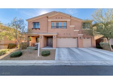 Inviting two-story home featuring a well-maintained front yard and a convenient two-car garage at 8137 Cape Flattery Ave, Las Vegas, NV 89147